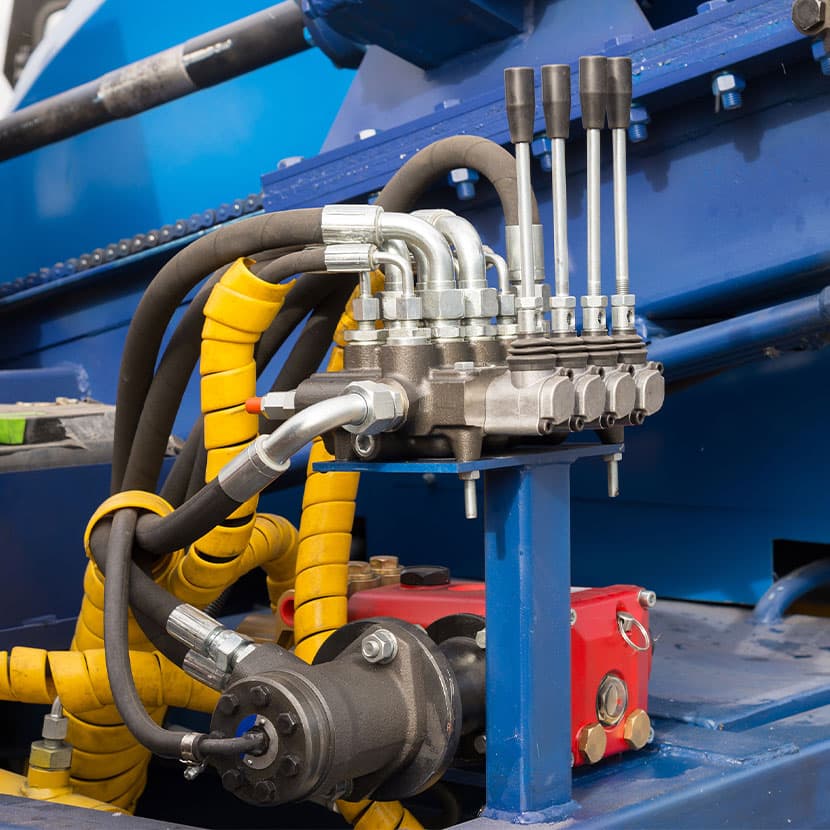 Close-up of hydraulic control system with multiple hoses and connectors for industrial machinery