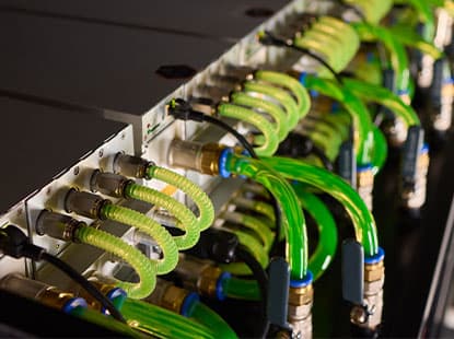 Liquid coolant flowing through tubing at back of server rack
