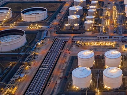 Close-up of oil barrels stored in industrial facility